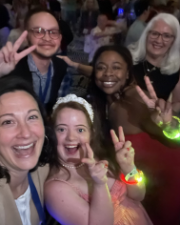 Selfie picture of smiling faces wearing glow bracelets