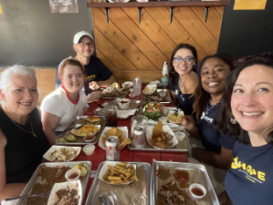 Selfie picture of a group of HOPE lab members around a table eating barbeque